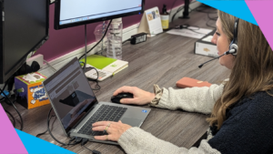 Woman sits at desk providing tech support for a virtual event