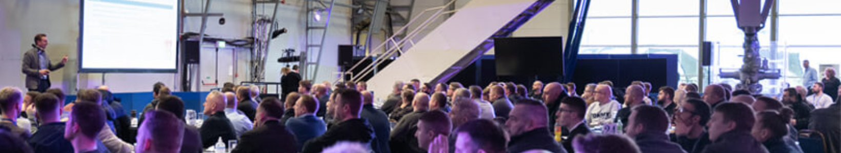 Presenter addressing a seated audience at the Concorde Conference Centre