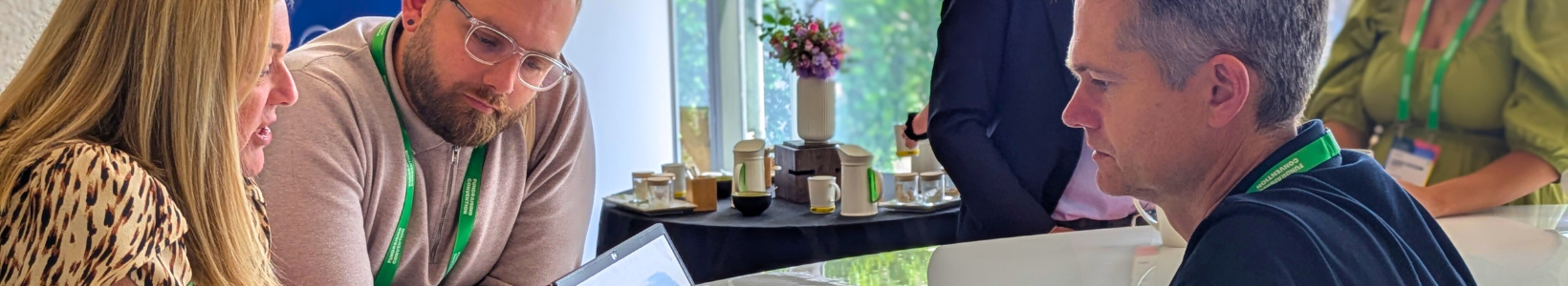 Conference Care team examining a document at the CIOF event